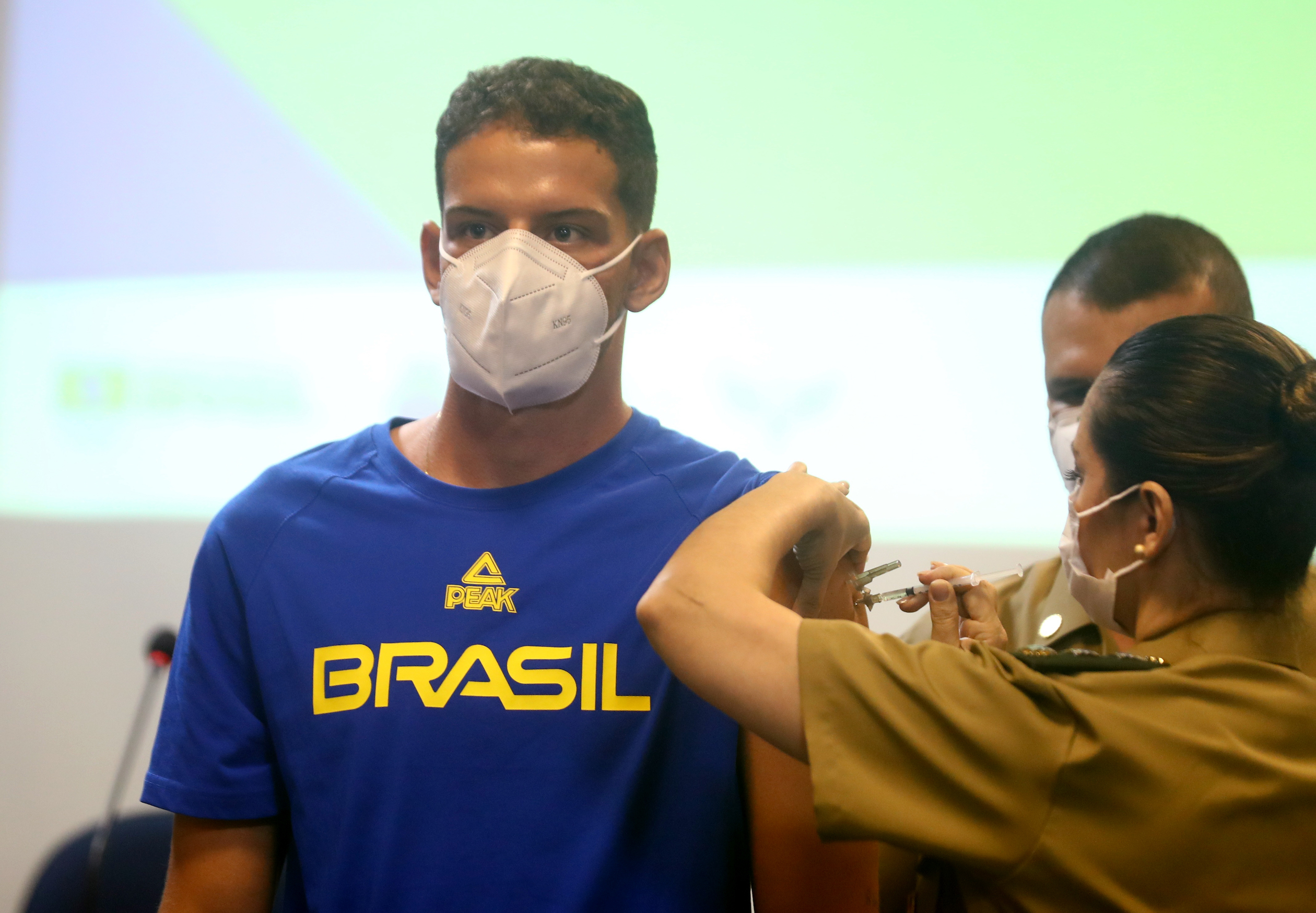 A Brazilian athlete receives a COVID-19 vaccine before traveling to Tokyo for the Olympics.